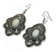 Boucles d'oreilles pendantes en metal argente cisele serties de pierres blanc